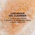 Peachy-toned gel cleanser with visible exfoliating particles and bubbles throughout the product.
