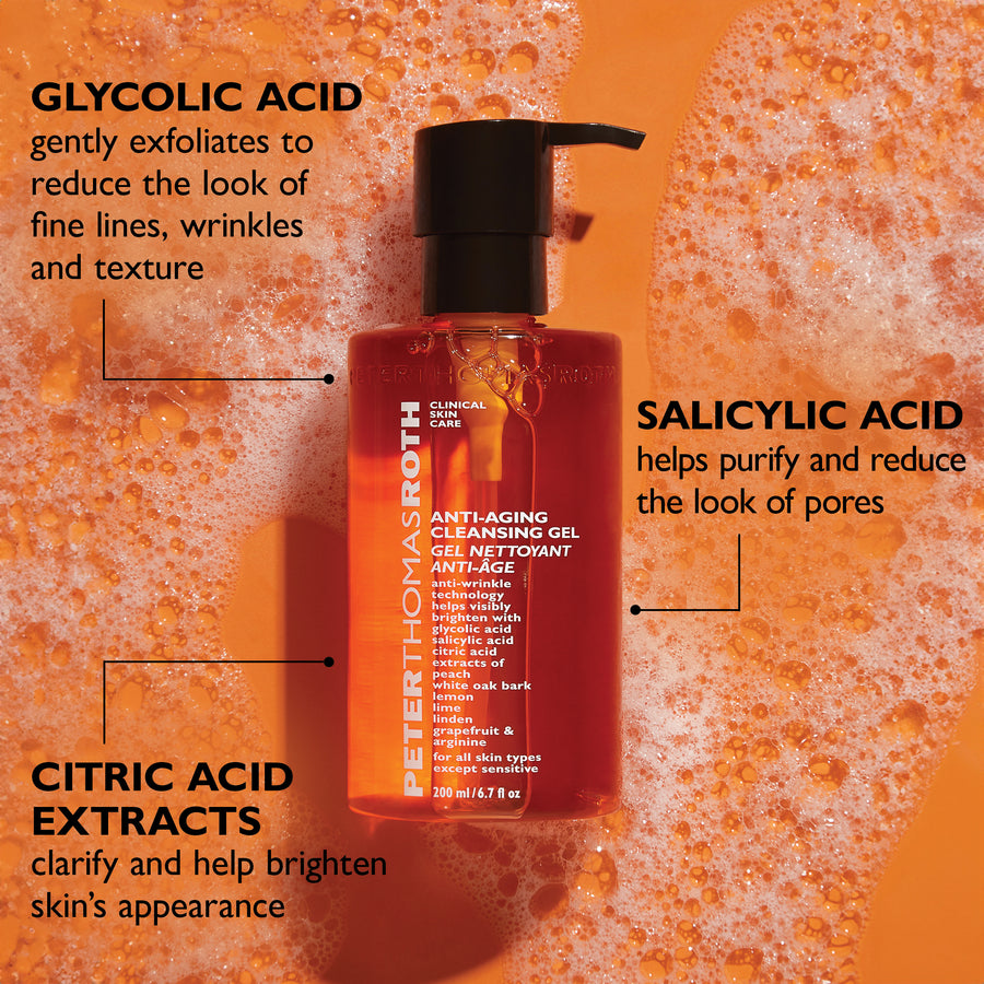 Red gel cleanser bottle with black pump dispenser on orange textured background with ingredient callouts.