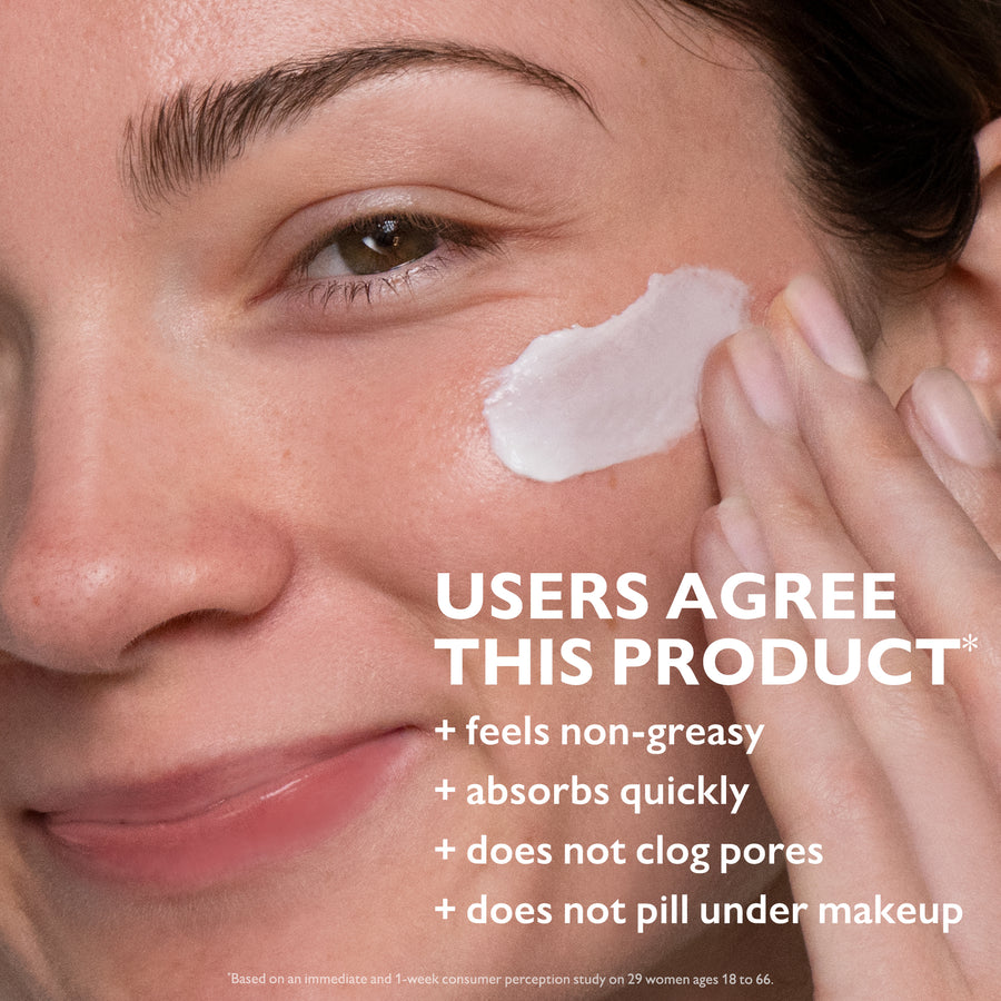 Person applying white cream to cheek, demonstrating product texture and consistency on skin.