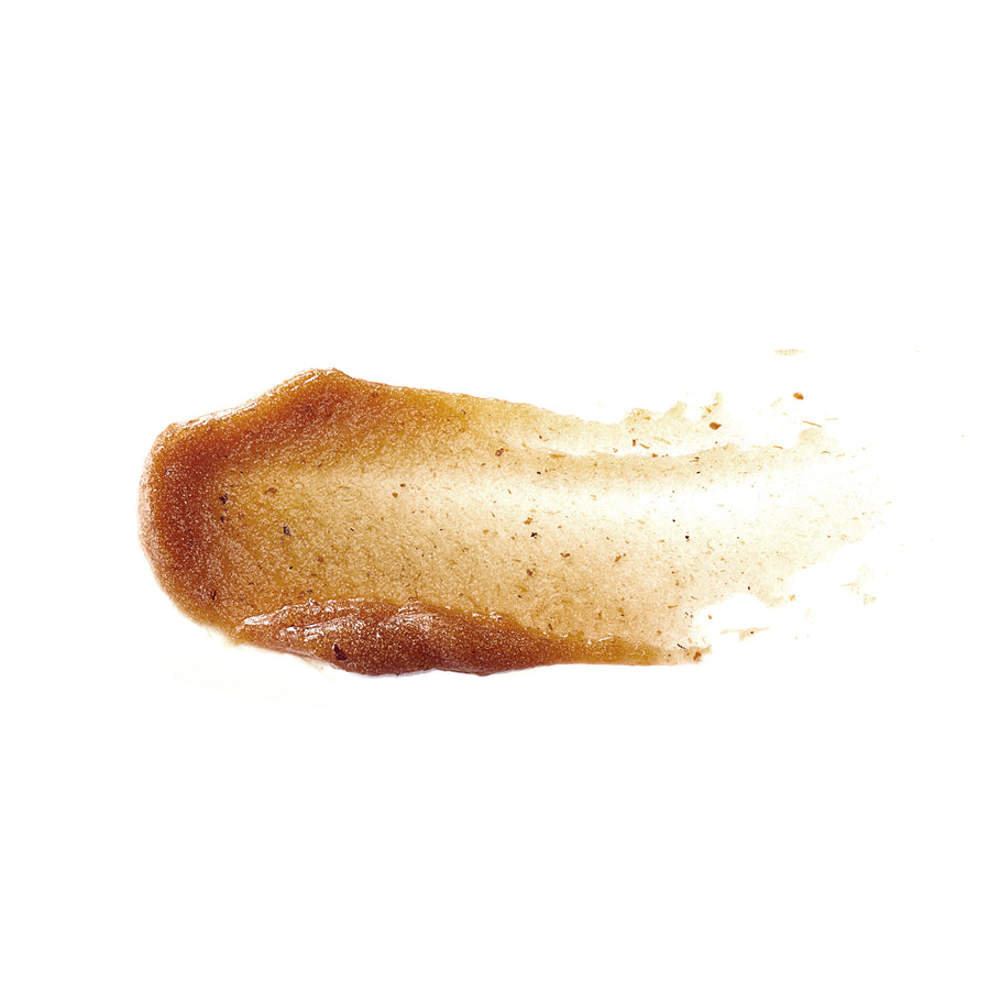 Orange-brown textured enzyme mask with granular particles dispersing across white background.