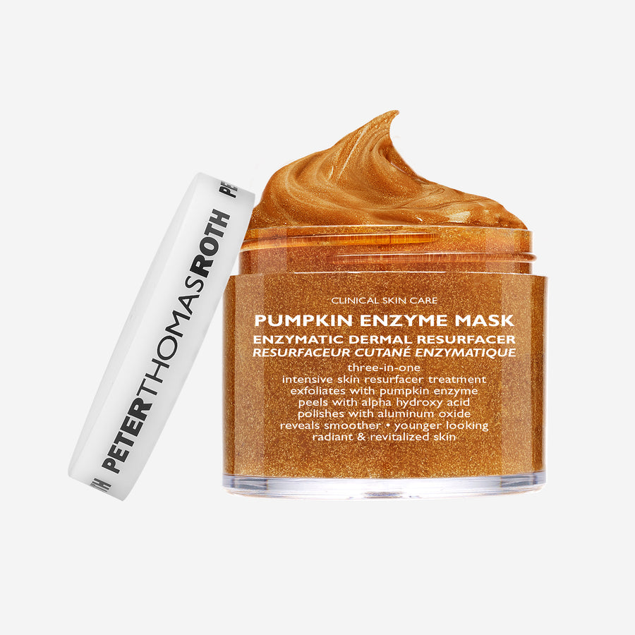 Peter Thomas Roth Pumpkin Enzyme Mask travel size jar with white tube and swirl of golden-orange mask product on top.