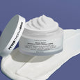 White jar of intensive anti-aging crème with lid, 100 ml, displayed on white product swatches against blue background.