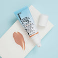 Light blue tube of Water Drench SPF 45 moisturizer with tinted product swatch on white paper against blue background.
