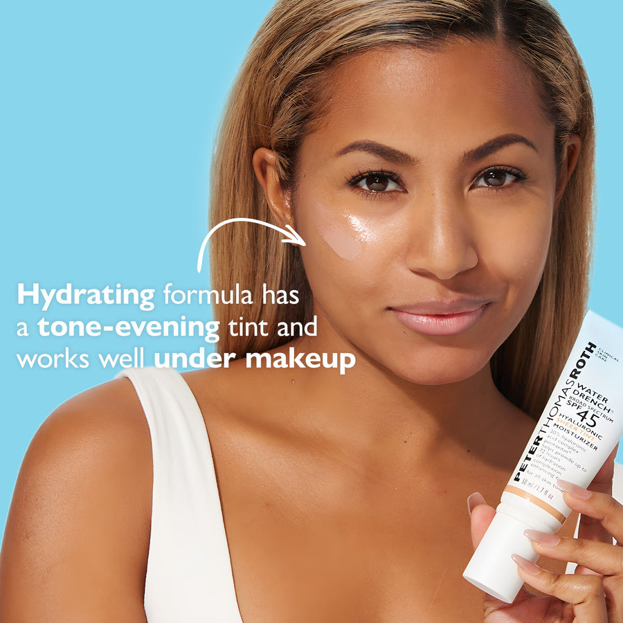 Woman with brown hair holding white SPF 45 moisturizer tube against blue background, showing product applied to face.