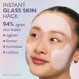 Person wearing beige collagen face patches on forehead and cheeks against a light blue background.