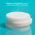 Stack of white exfoliating pads against turquoise background with text describing 20% exfoliating complex.