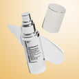 White spray bottle of Un-Wrinkle eye concentrate with silver cap and matching cylindrical container on cream background.