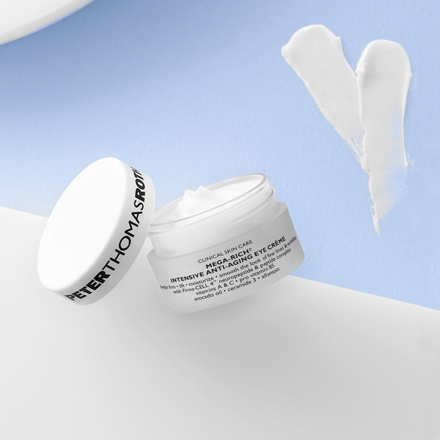 White jar of eye crème with matching lid displayed on blue and white background with cream swatches.