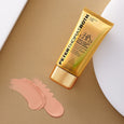 Gold tube of Peter Thomas Roth 24K Gold Prism Cream with beige applicator cap and pink cream swatches on tan background.