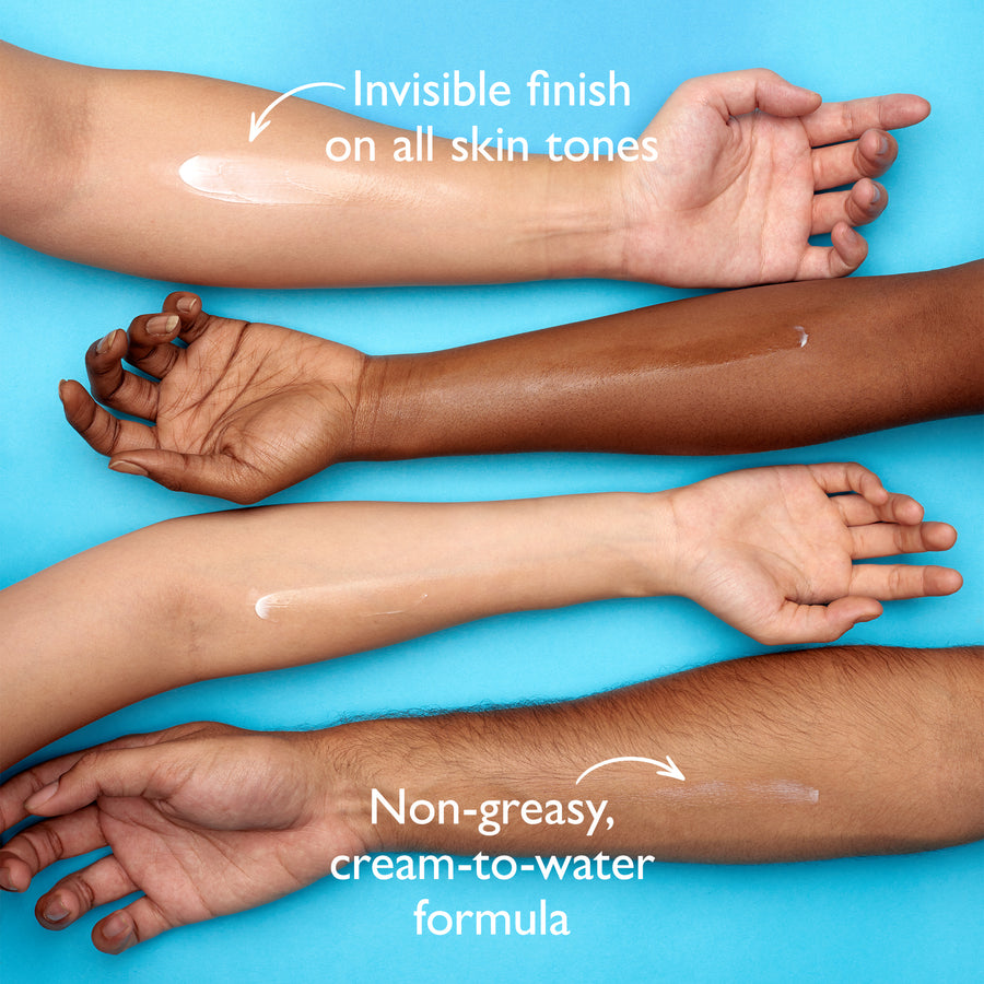 Four arms displaying moisturizer swatches on different skin tones against a blue background.