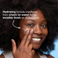 Light-textured moisturizer with SPF 45 sunscreen applied to person's cheek, showing sheer coverage on deep skin tone.