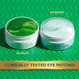 Two gel eye patches in clear containers—one with green cucumber formula labeled "De-Puff" and one with light blue hydrating f