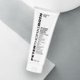 White tube of Peter Thomas Roth Modern Classic Shave Cream labeled 207 ml / 7 fl oz on gray and white background.