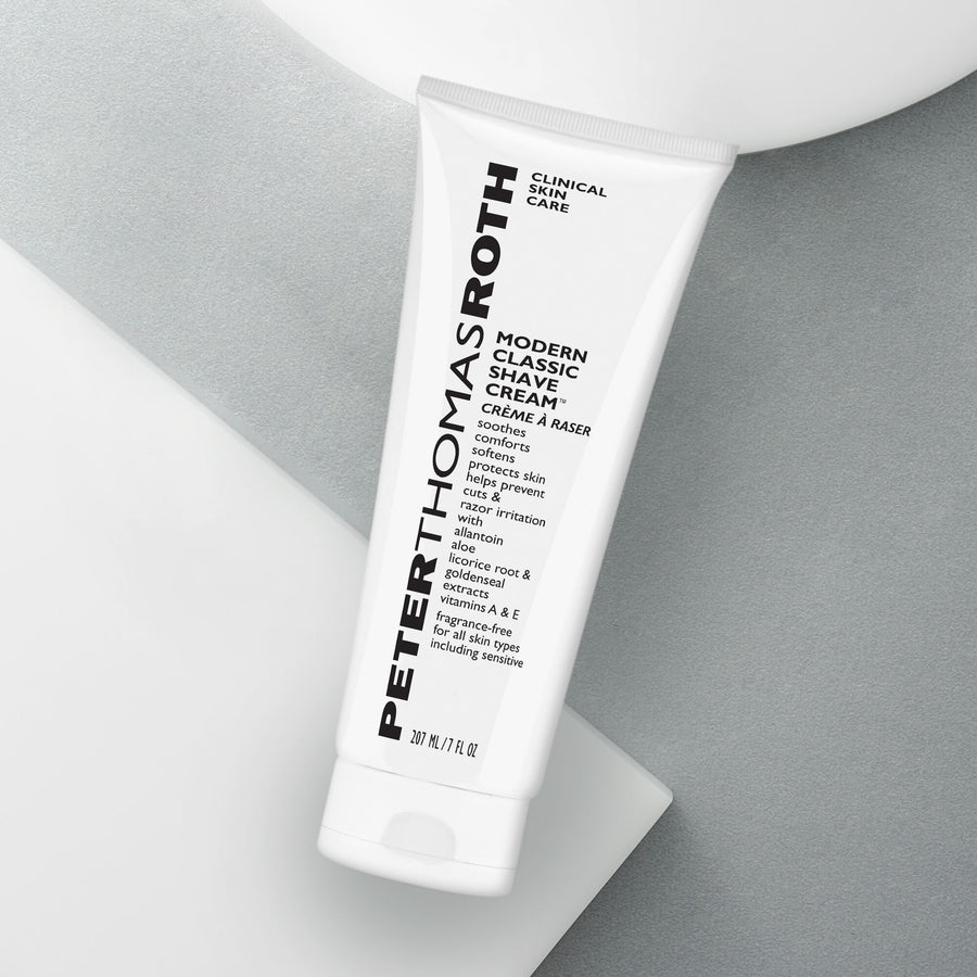White tube of Peter Thomas Roth Modern Classic Shave Cream labeled 207 ml / 7 fl oz on gray and white background.