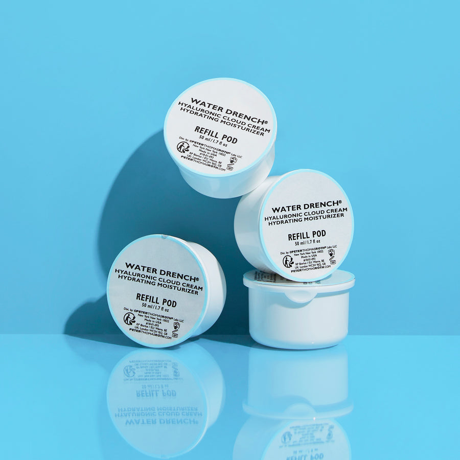 Three white cylindrical refill pods labeled Water Drench Hyaluronic Cloud Cream on light blue background.