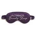 Purple silk eye mask with "Ultimate Beauty Sleep" text and adjustable elastic straps.
