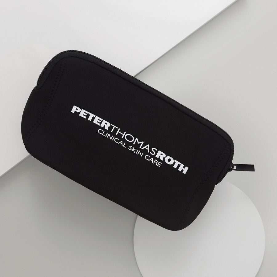 Black travel pouch with "Peter Thomas Roth Clinical Skin Care" text and top zipper.