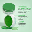Three green gel eye patches in containers with cucumber extract, caffeine, and arnica ingredients labeled.