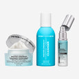 Three Peter Thomas Roth skincare products: white jar with silver lid containing cream, turquoise bottle cleanser, and silver 