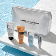 Silver Peter Thomas Roth cosmetic bag with five skincare product tubes in various sizes arranged beside it.